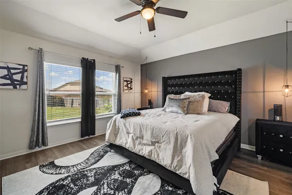 a bedroom with a large bed and a window