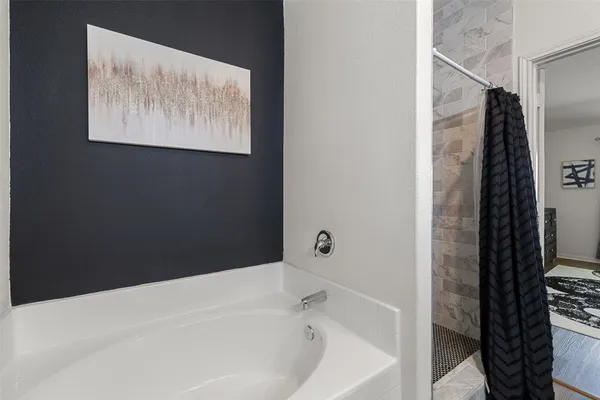 a bathroom with a bathtub and shower