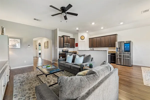 a living room with furniture and kitchen view