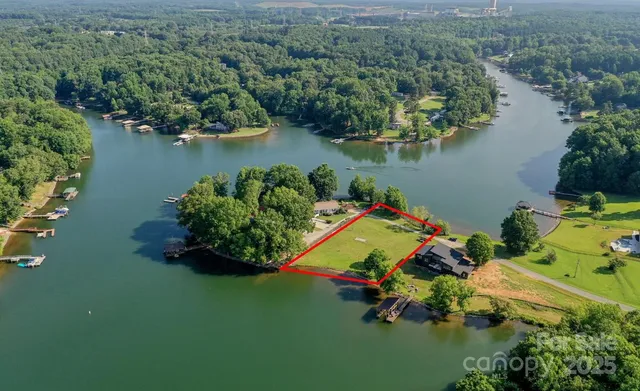 an aerial view of a house with a lake view