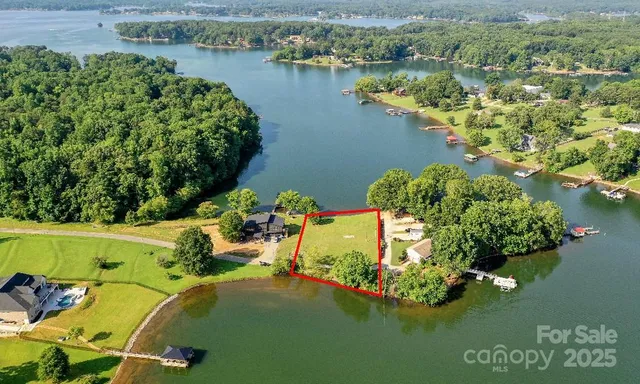 an aerial view of a house with a lake view