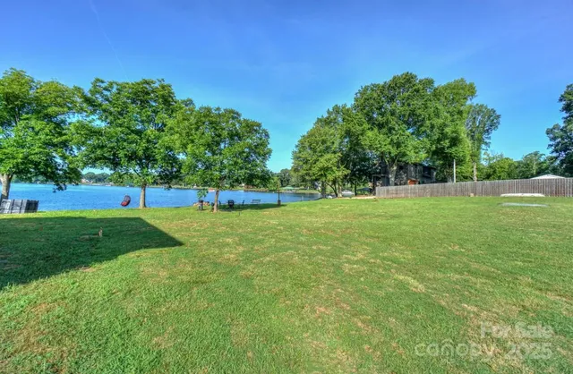a view of green field with trees in the background