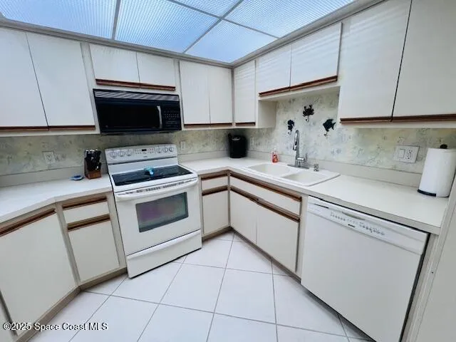 a kitchen with cabinets stainless steel appliances and a sink