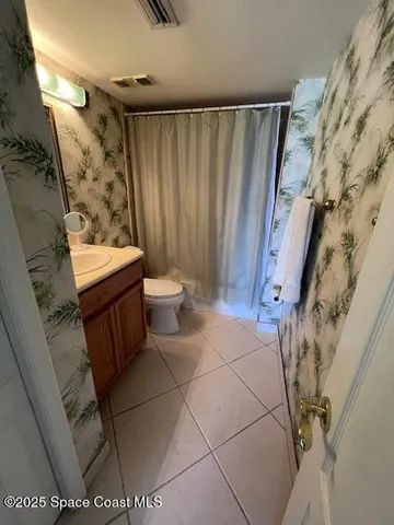 a bathroom with a toilet and shower