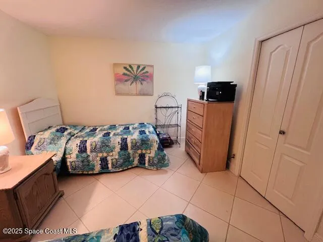 a bedroom with a bed and a tv on the dresser