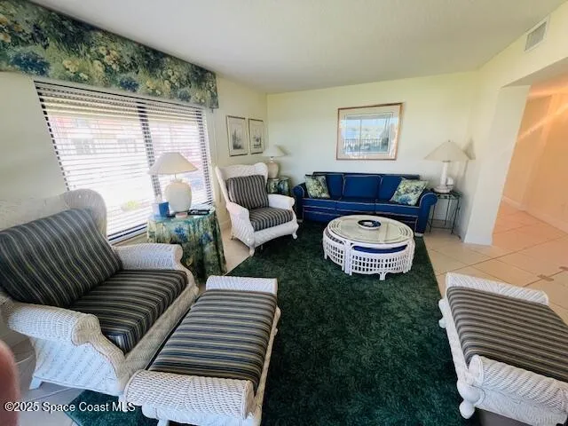 a living room with furniture a rug and a large window