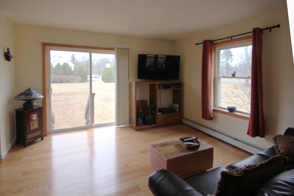 130 Plumtree Road Sunderland, MA 01375 - Photo 3 of 19 a living room with furniture and a flat screen tv