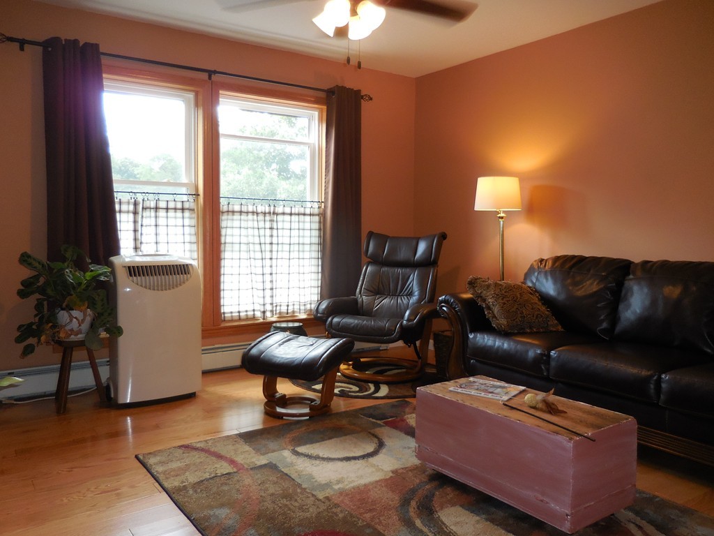 130 Plumtree Road Sunderland, MA 01375 - Photo 5 of 19 a living room with furniture a lamp and a window