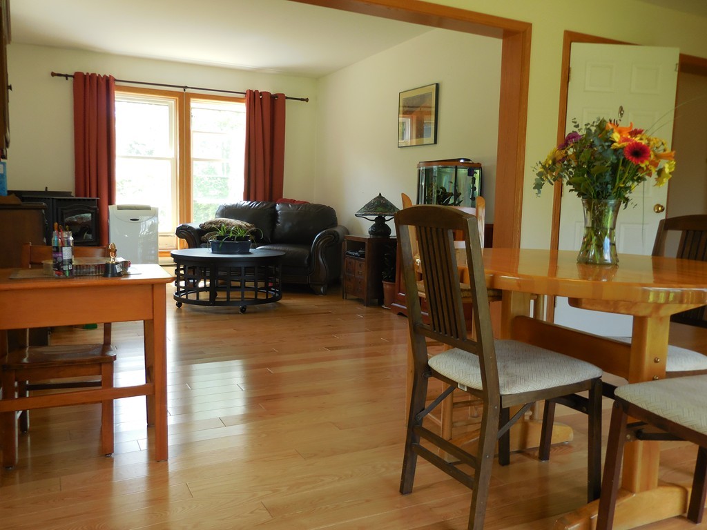 130 Plumtree Road Sunderland, MA 01375 - Photo 7 of 19 a living room with furniture wooden floor and a floor to ceiling window