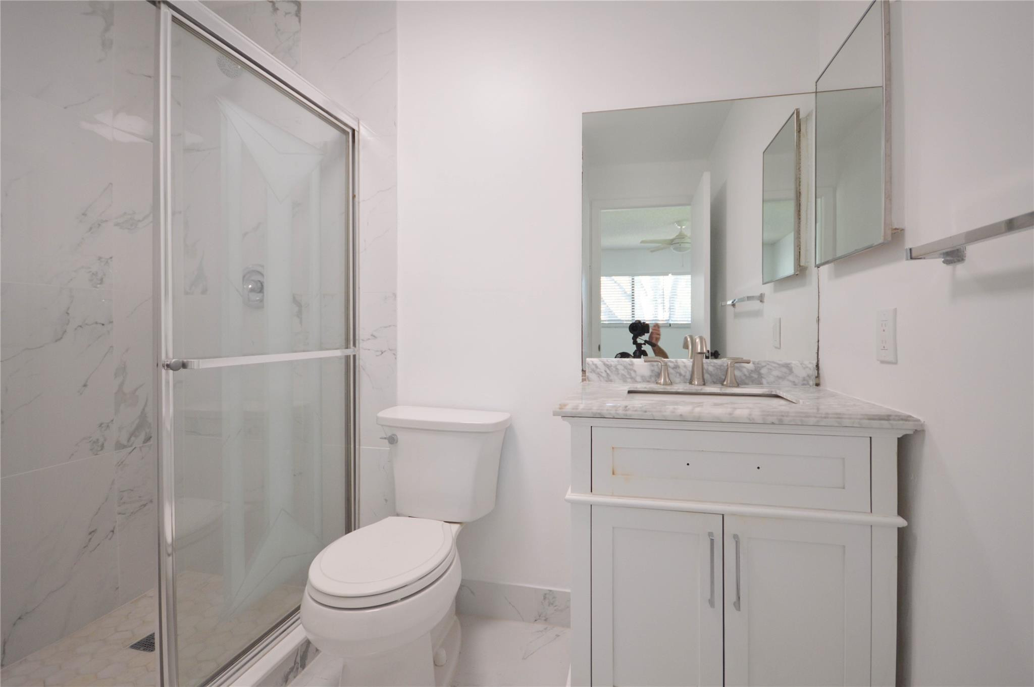 9499 West McNab Road, Unit 208 Tamarac, FL 33321 - Photo 8 of 19 a bathroom with a granite countertop sink toilet and shower
