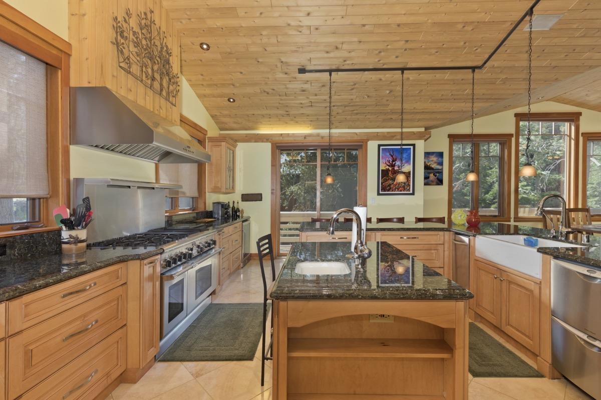 2500 Old Mammoth Road Mammoth Lakes, CA 93546 - Photo 19 of 48 a kitchen with stainless steel appliances granite countertop a sink and wooden cabinets