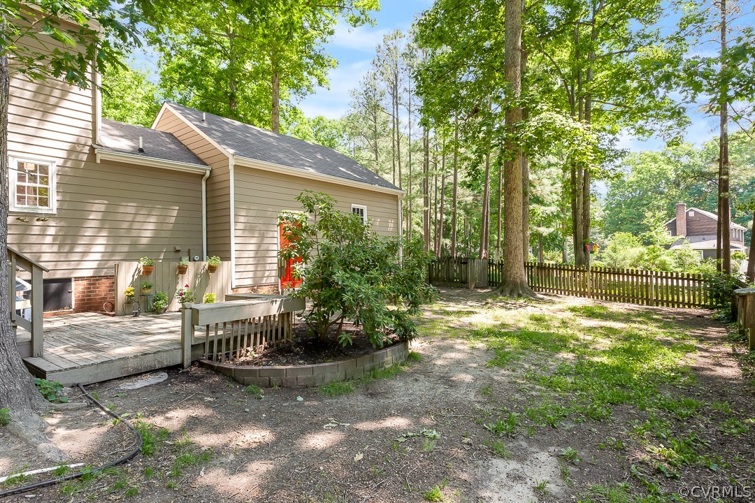 13815 Sterlings Bridge Road Midlothian, VA 23112 - Photo 25 of 27 a view of backyard with a table and chairs and wooden fence