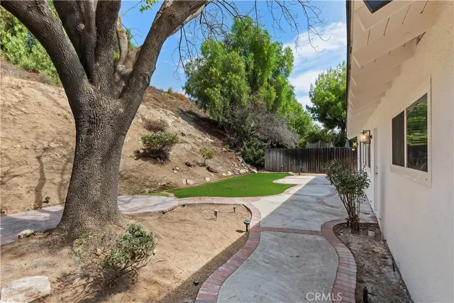 a view of a street with a house in the background