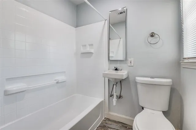a bathroom with a sink a toilet and bathtub