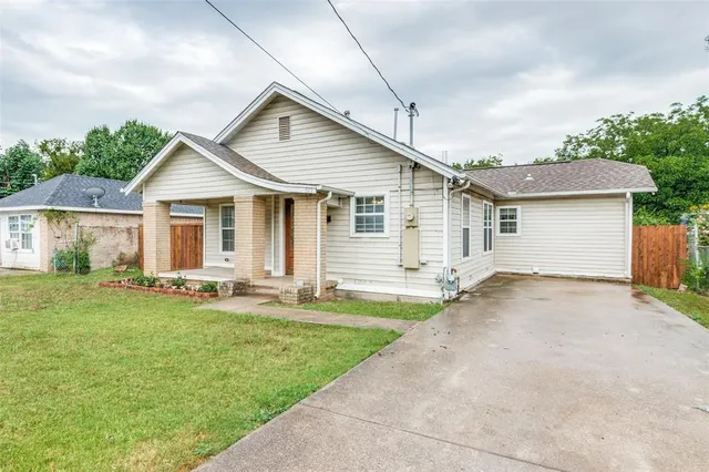 a front view of house with a garden and patio