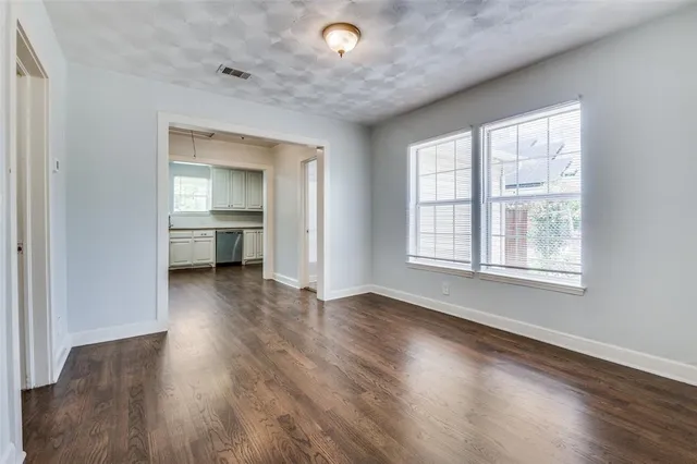 a view of a livingroom with wooden floor and a window