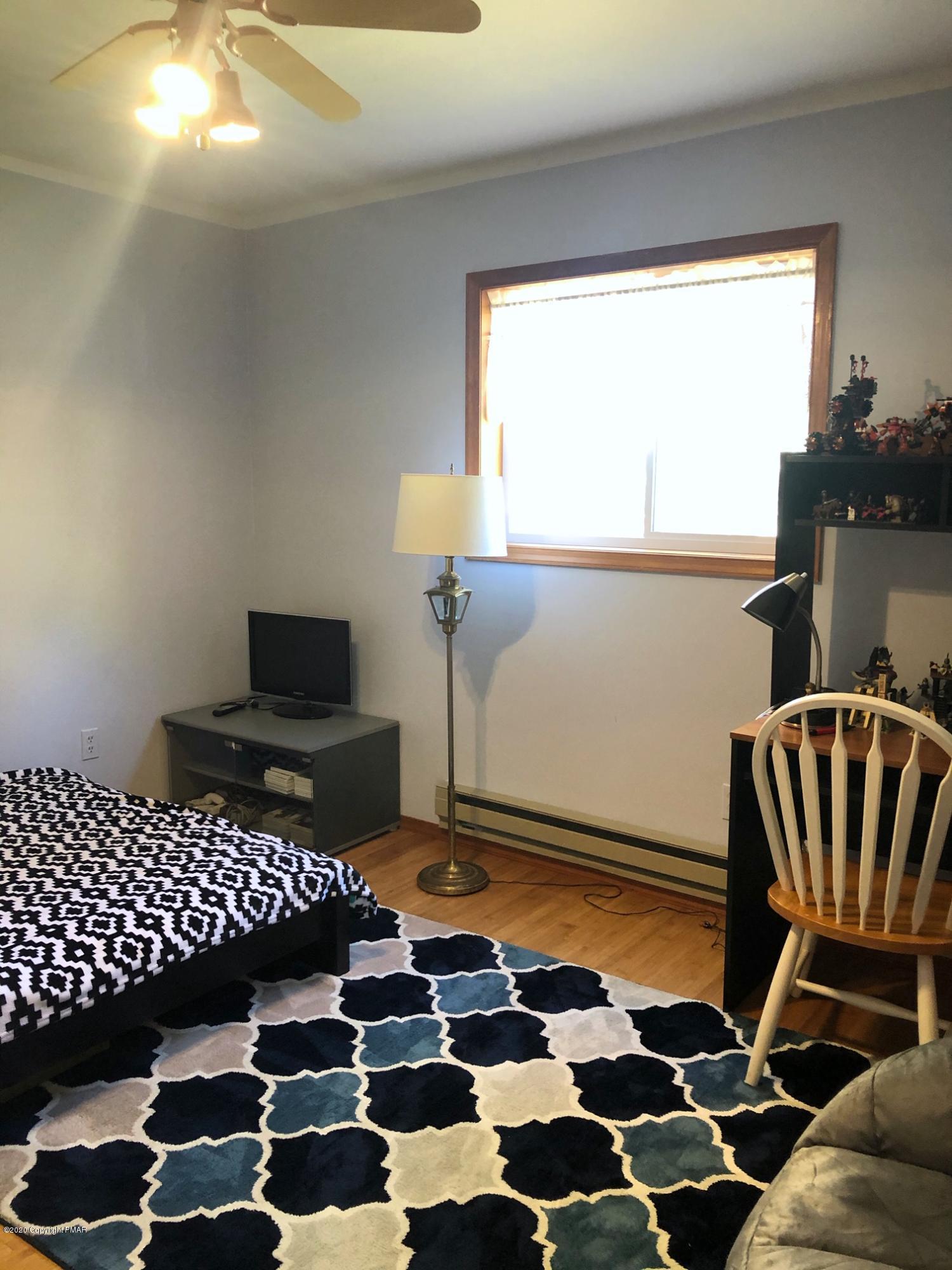 223 Sage Road Long Pond, PA 18334 - Photo 23 of 28 a rug sitting area with wooden floor