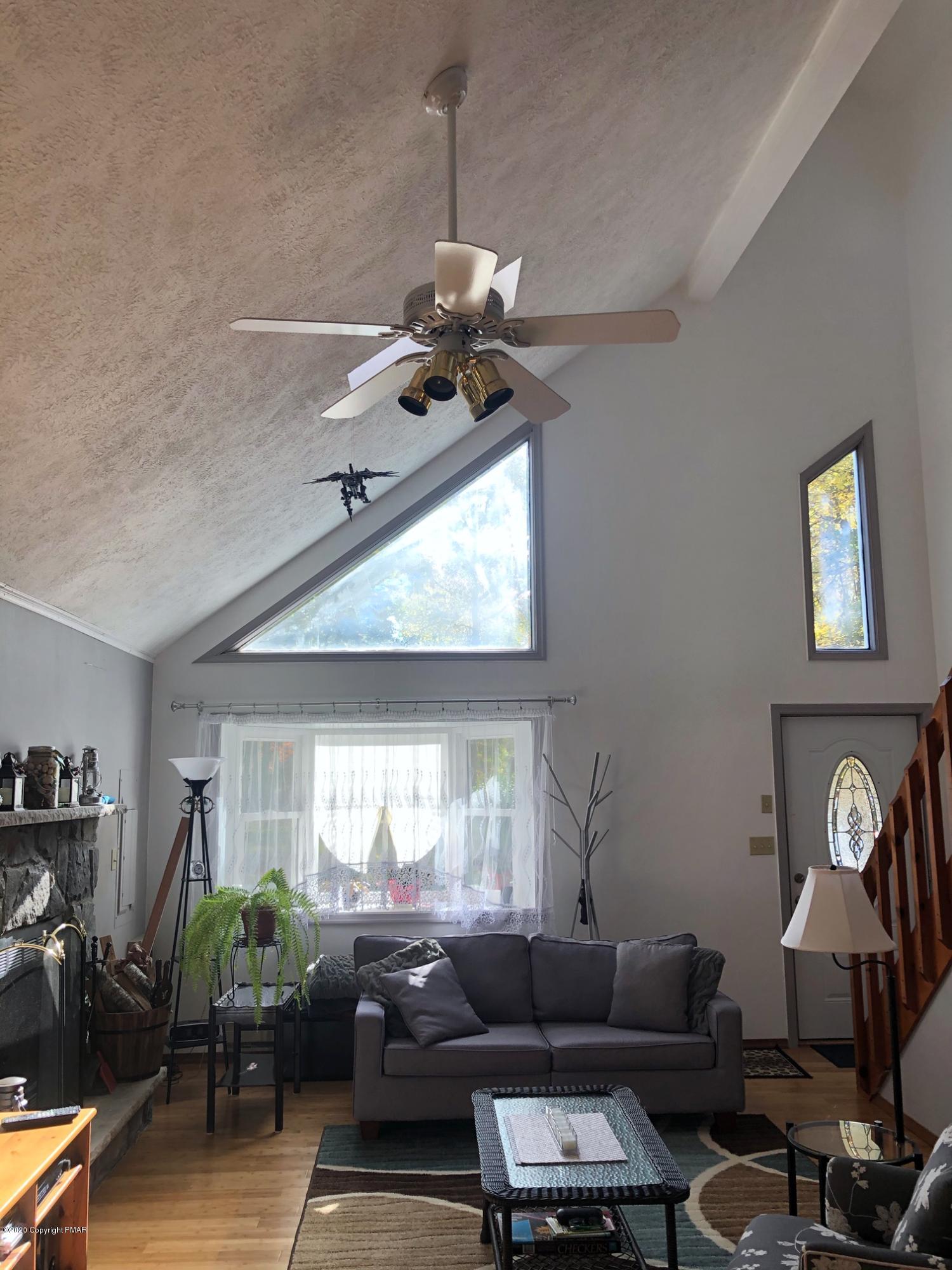 223 Sage Road Long Pond, PA 18334 - Photo 7 of 28 a living room with furniture a window and a chandelier
