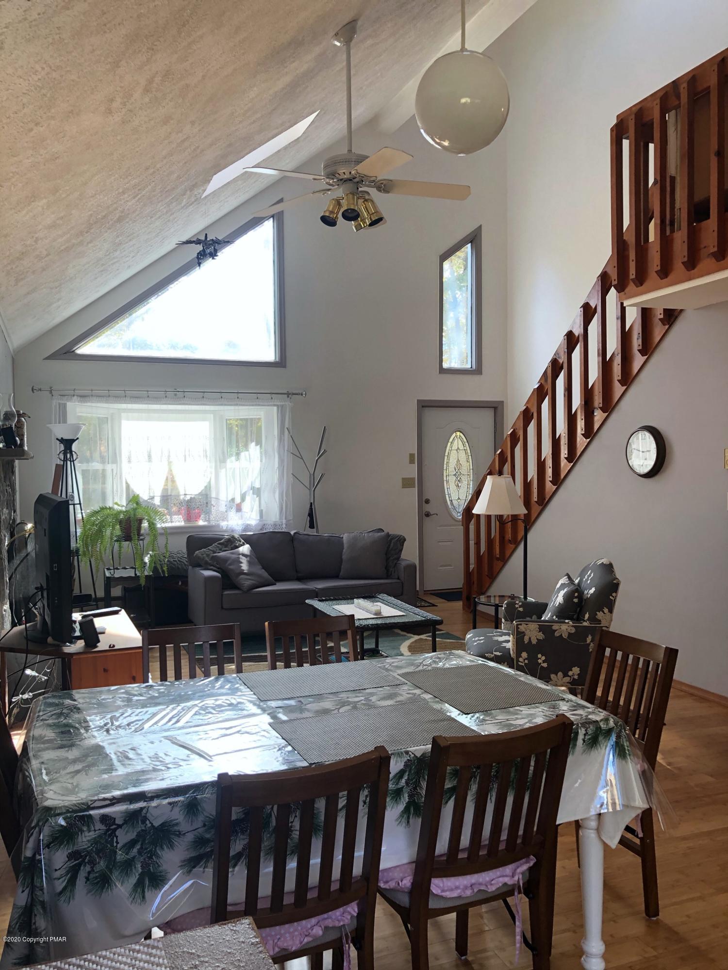 223 Sage Road Long Pond, PA 18334 - Photo 8 of 28 a view of a dining room with furniture window and wooden floor