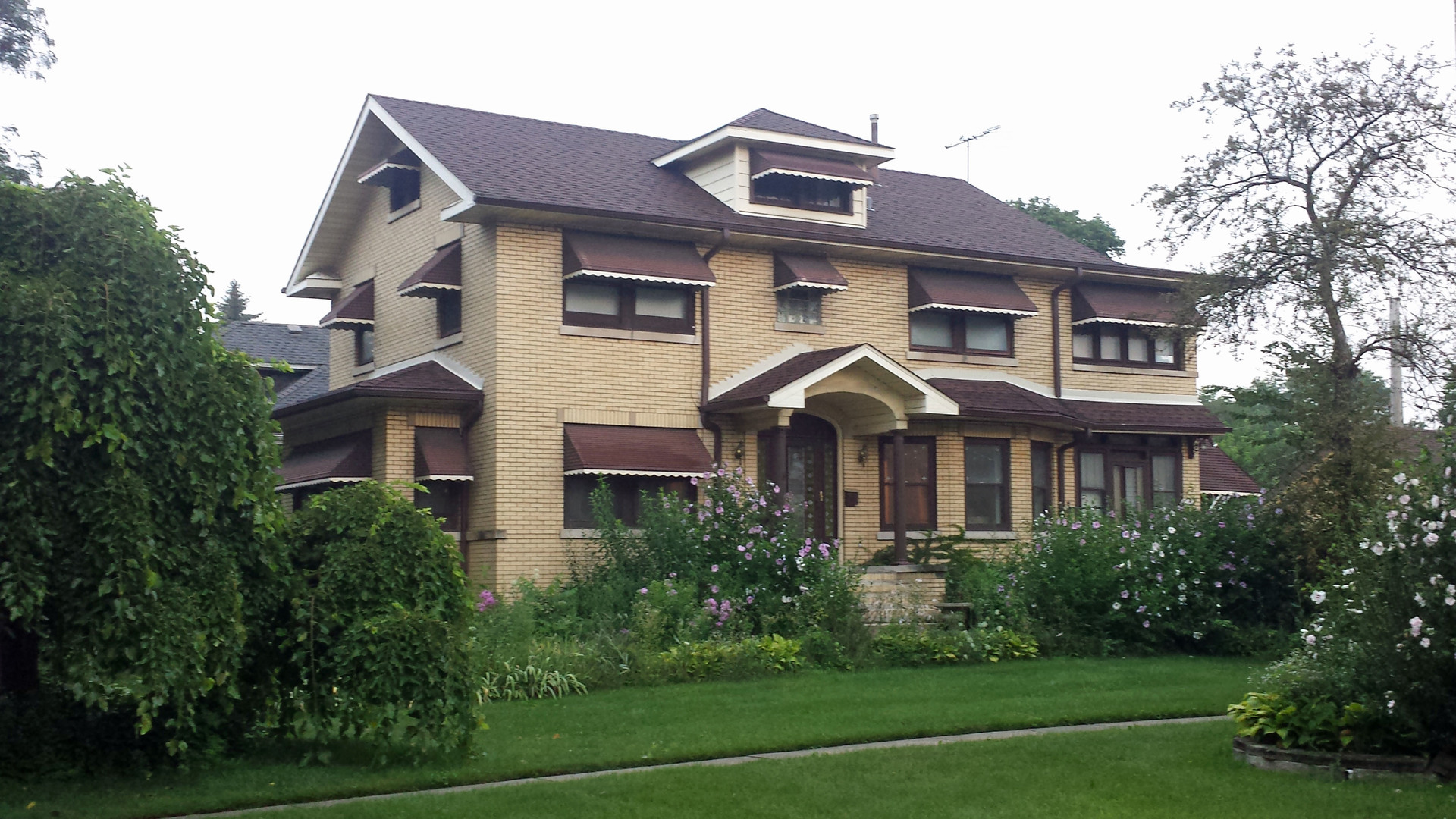 a front view of a house with a garden