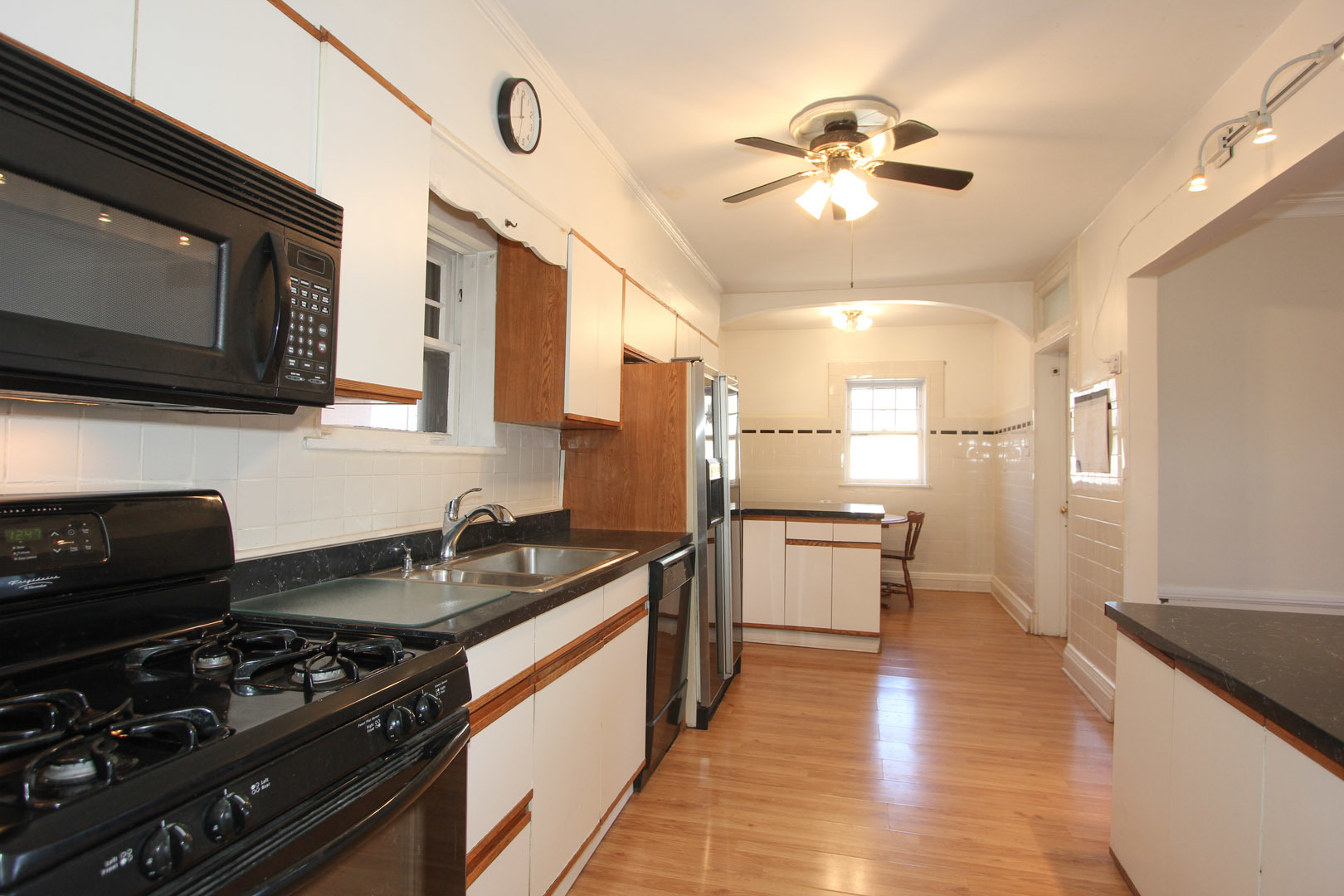 7610 Washington Boulevard River Forest, IL 60305 - Photo 12 of 30 a kitchen with a stove a sink and a microwave