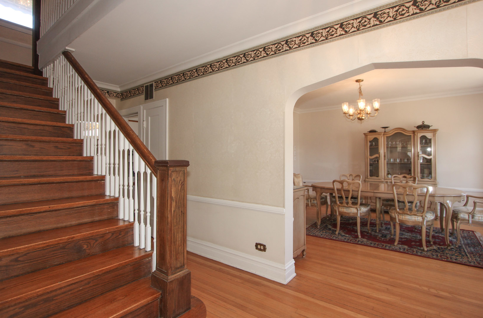 7610 Washington Boulevard River Forest, IL 60305 - Photo 16 of 30 a view of a room with wooden floor staircase and a way to kitchen