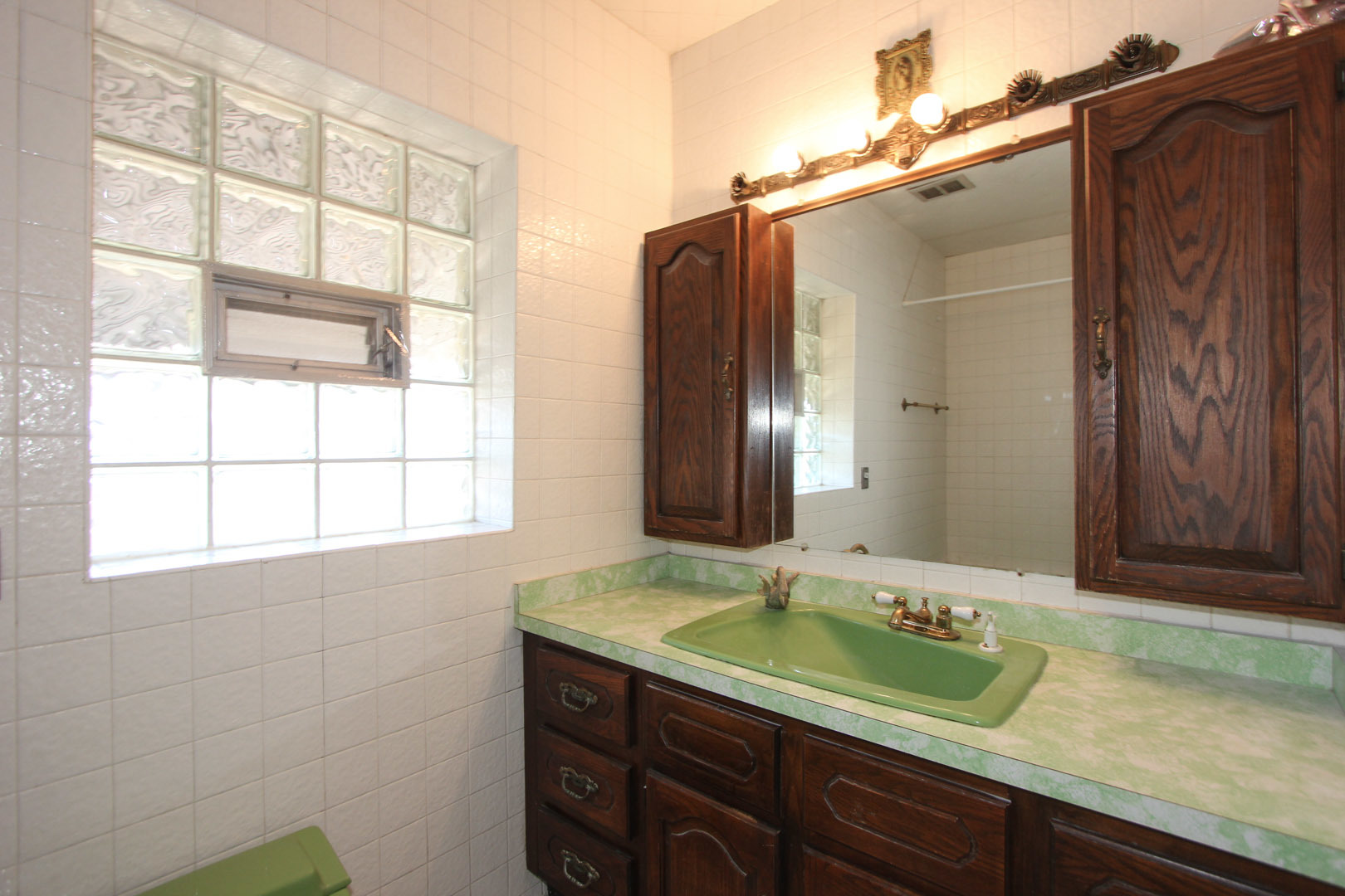 7610 Washington Boulevard River Forest, IL 60305 - Photo 27 of 30 a bathroom with a granite countertop sink and a large mirror