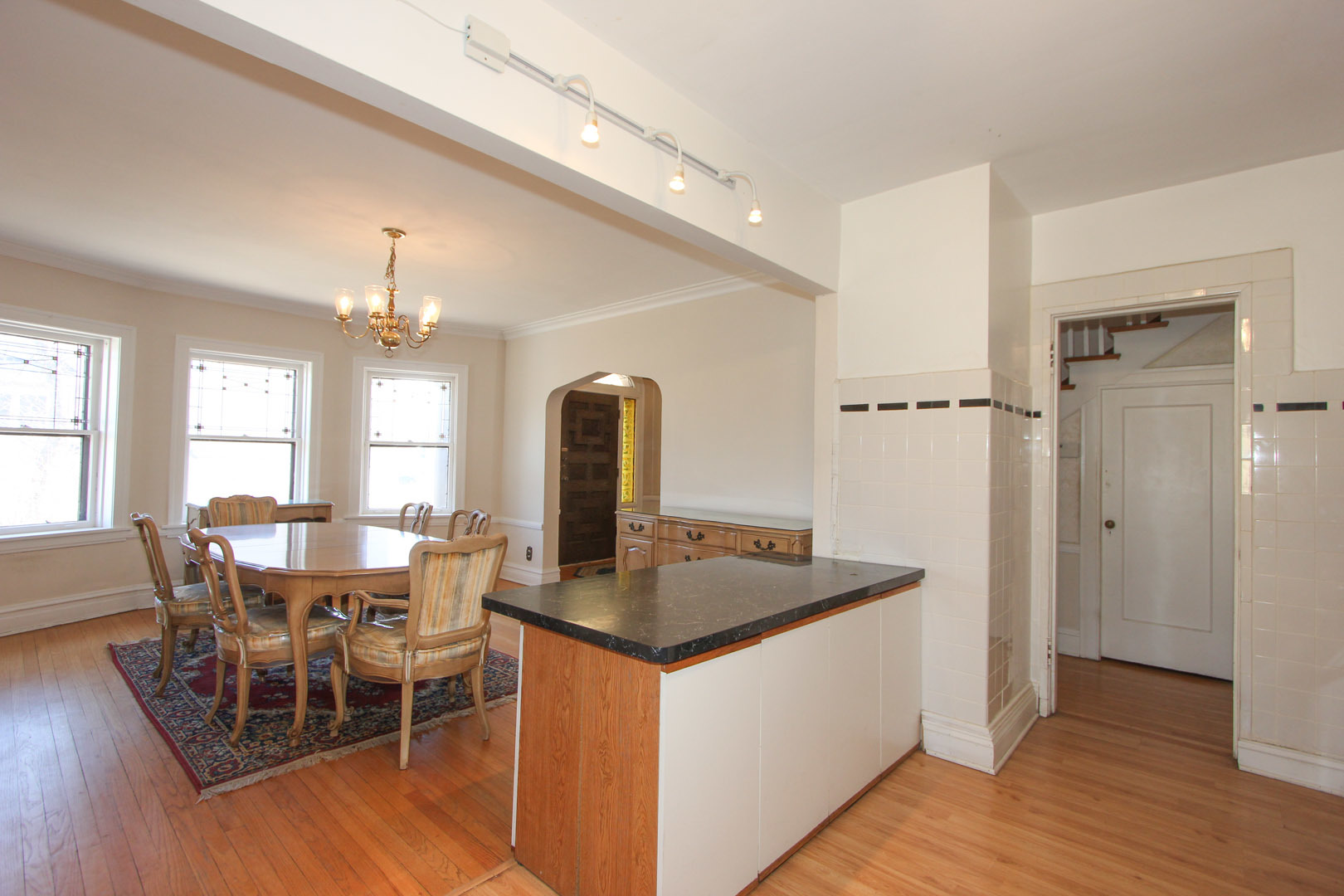 7610 Washington Boulevard River Forest, IL 60305 - Photo 9 of 30 a dining hall with granite countertop a dining table chairs and white cabinets