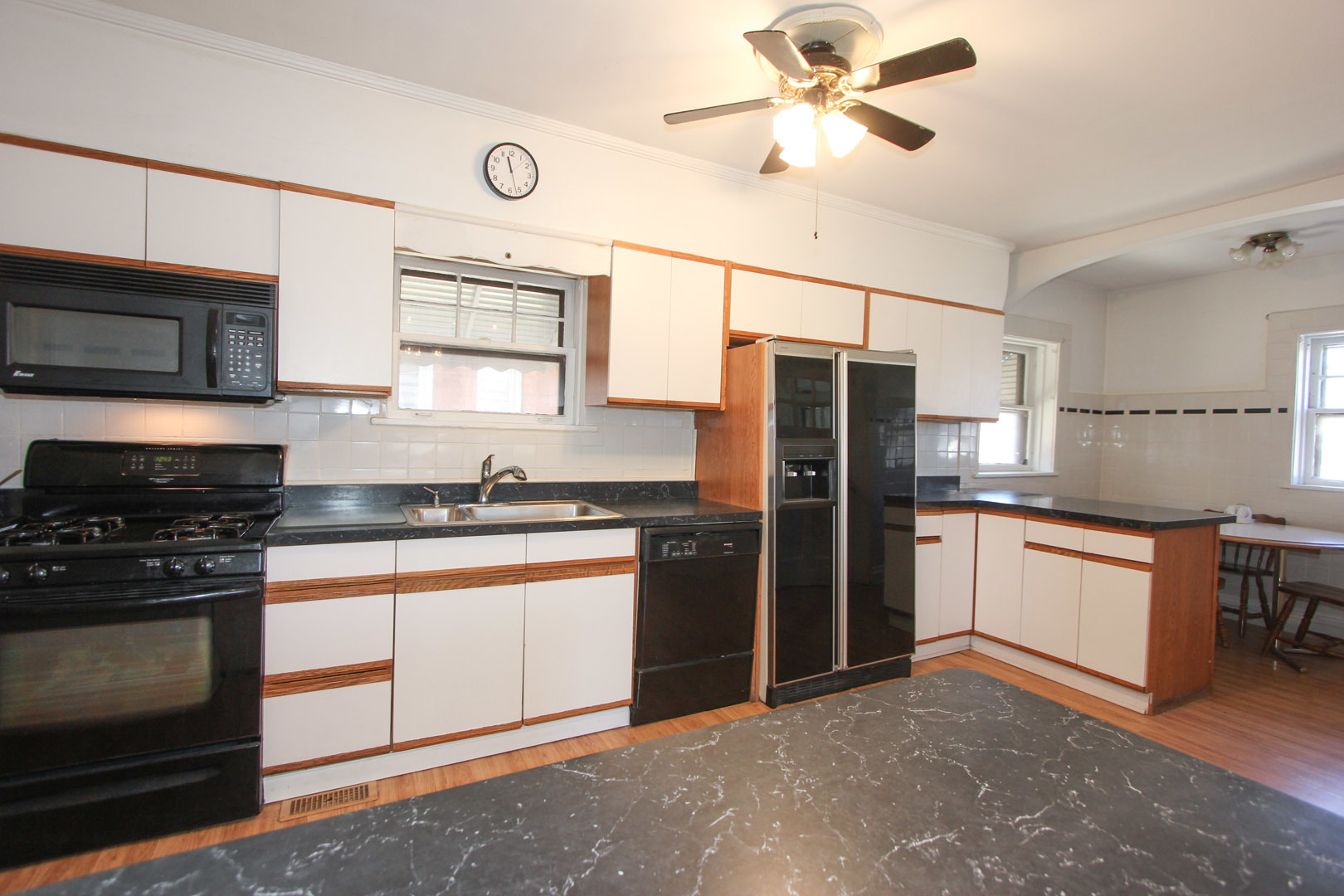 7610 Washington Boulevard River Forest, IL 60305 - Photo 10 of 30 a kitchen with stainless steel appliances granite countertop a stove refrigerator sink and microwave