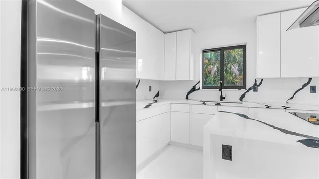 a view of a kitchen with a sink and a refrigerator