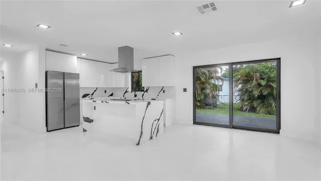 a view of water heater room with stainless steel appliances
