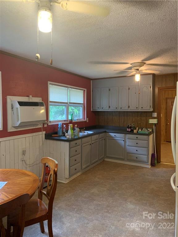 2040 Knight Road Lancaster, SC 29720 - Photo 30 of 35 a kitchen with stainless steel appliances kitchen island granite countertop a table and chairs in it
