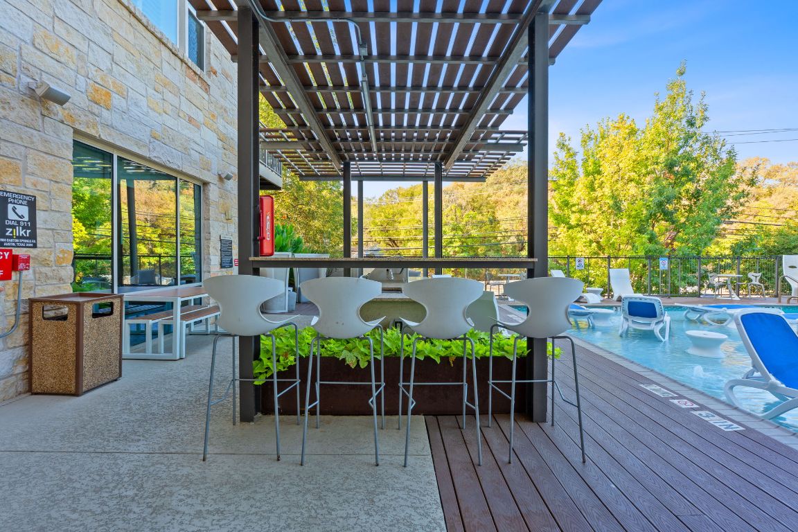 1900 Barton Springs Road, Unit 2019 Austin, TX 78704 - Photo 19 of 30 a view of a patio with table and chairs and wooden floor