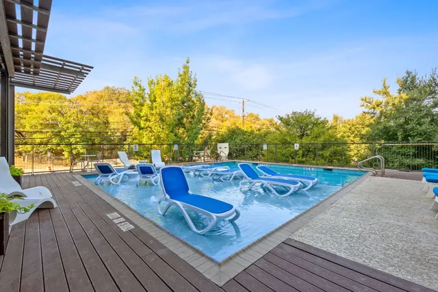 a view of a swimming pool with chairs