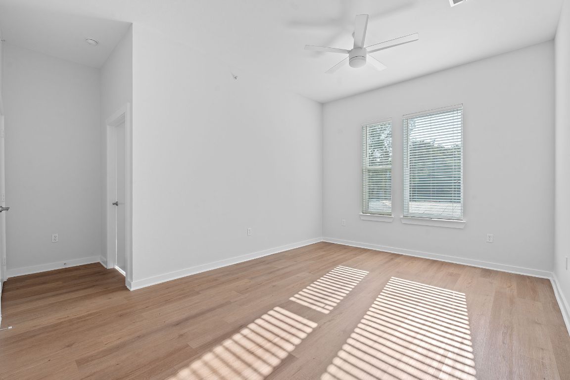 1900 Barton Springs Road, Unit 2019 Austin, TX 78704 - Photo 3 of 30 a view of an empty room with wooden floor and a window