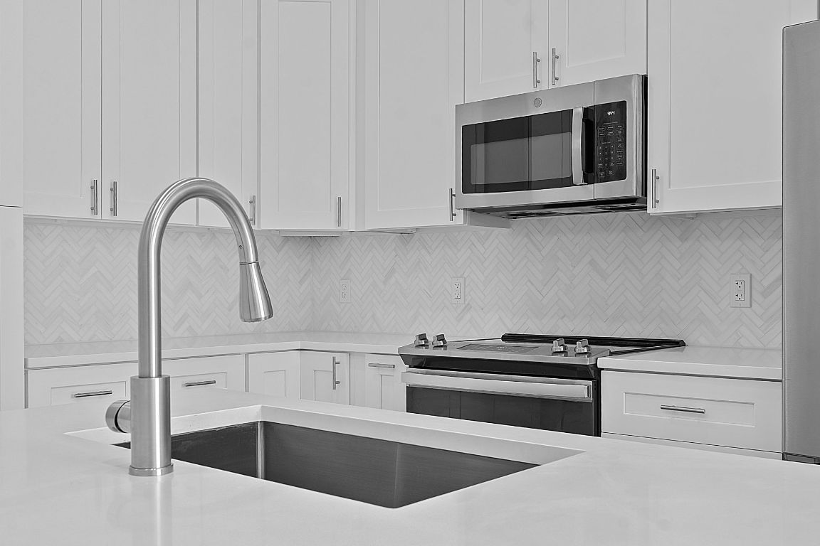 1900 Barton Springs Road, Unit 2019 Austin, TX 78704 - Photo 7 of 30 a kitchen with stainless steel appliances white cabinets and a stove top oven