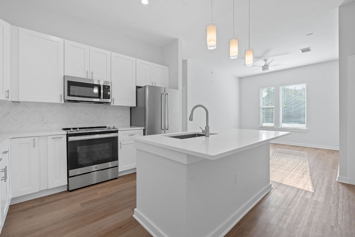 1900 Barton Springs Road, Unit 2019 Austin, TX 78704 - Photo 8 of 30 a kitchen with stainless steel appliances a stove a sink and a microwave