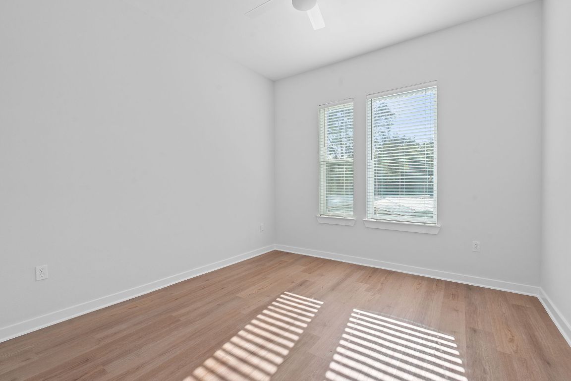 1900 Barton Springs Road, Unit 2019 Austin, TX 78704 - Photo 10 of 30 an empty room with wooden floor and windows