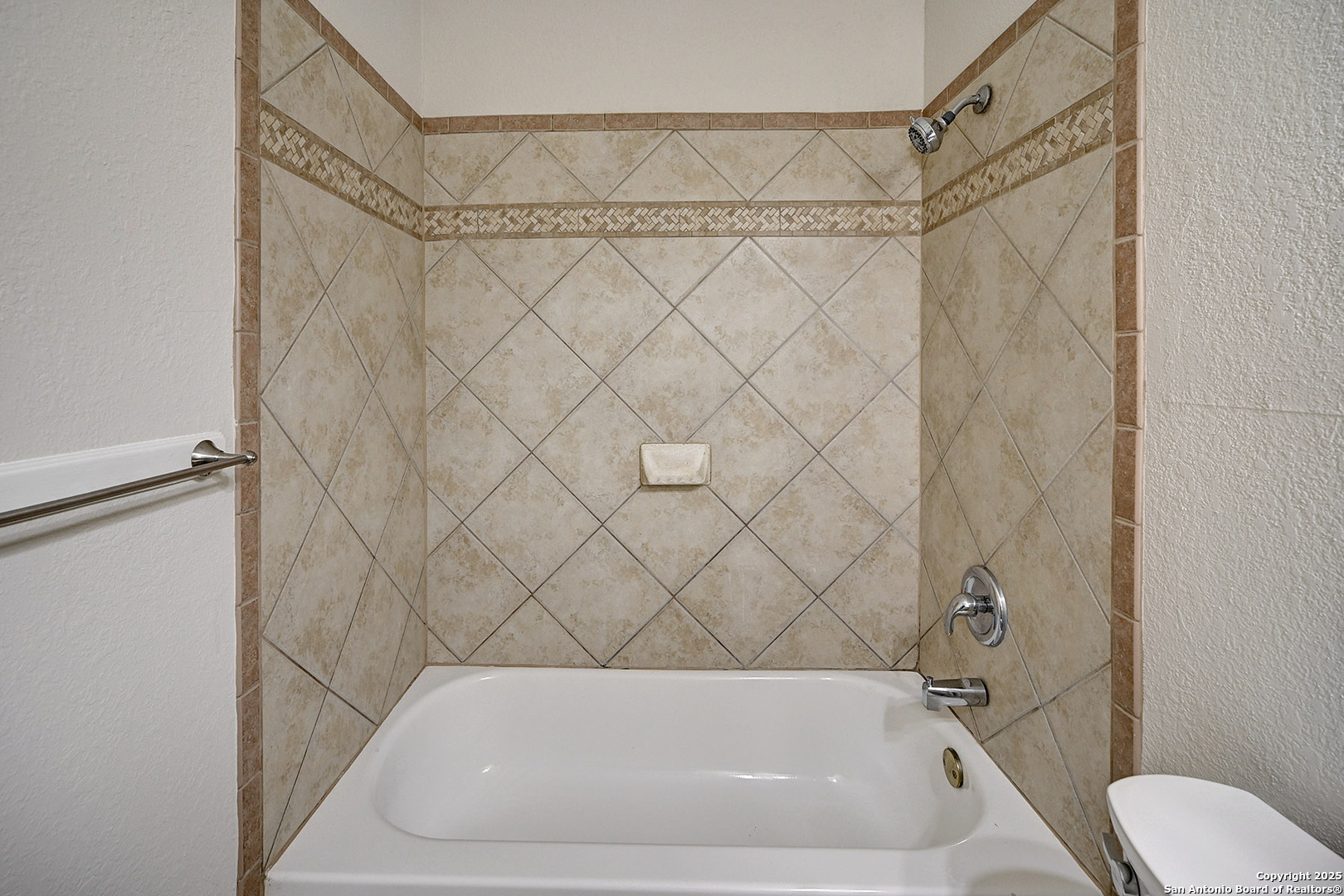 7543 Beaver Tree San Antonio, TX 78249 - Photo 34 of 38 a bathroom with a white bath tub and a shower curtain