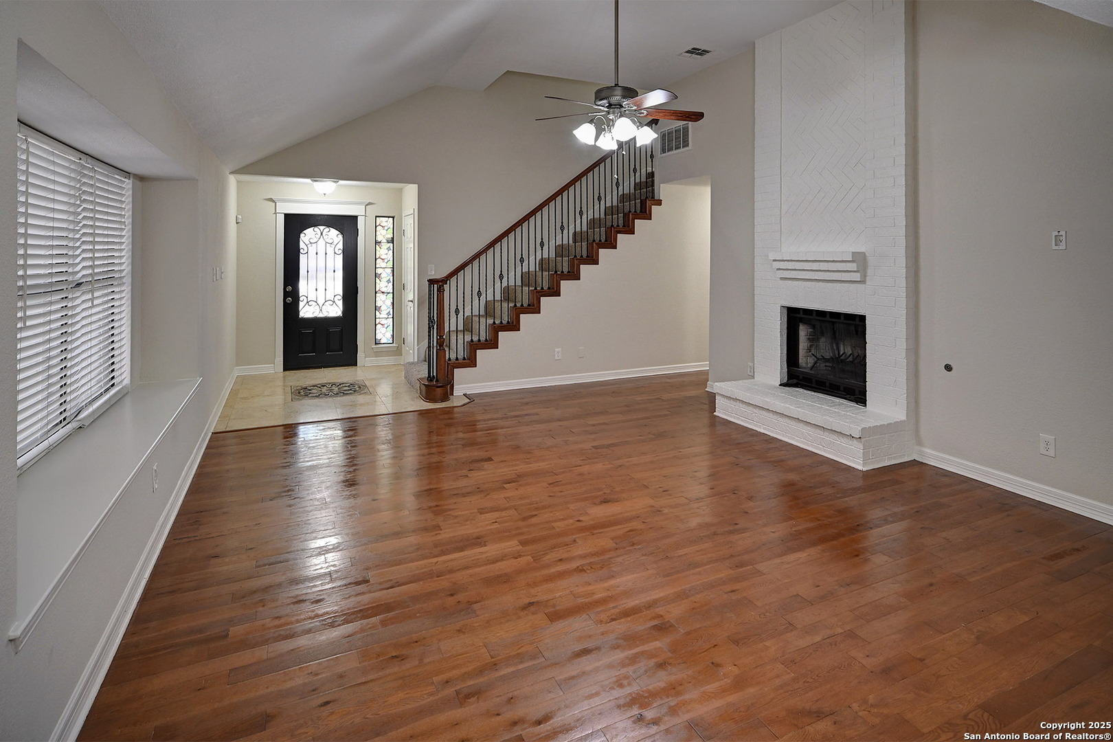 7543 Beaver Tree San Antonio, TX 78249 - Photo 7 of 38 wooden floor chandelier and windows in a room