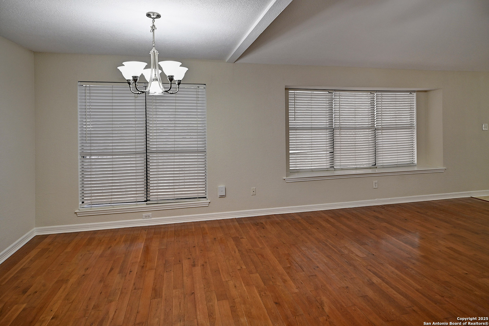 7543 Beaver Tree San Antonio, TX 78249 - Photo 8 of 38 a view of an empty room with wooden floor and a window