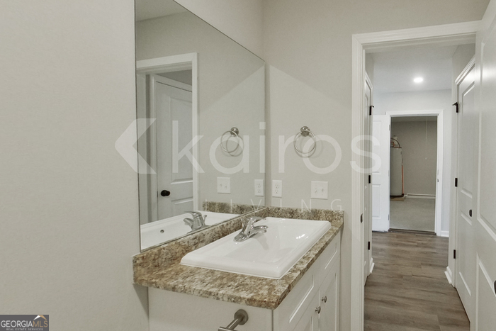 122 Cottage Grove Road Brunswick, GA 31525 - Photo 13 of 20 a en suite bathroom with a granite countertop sink and a mirror