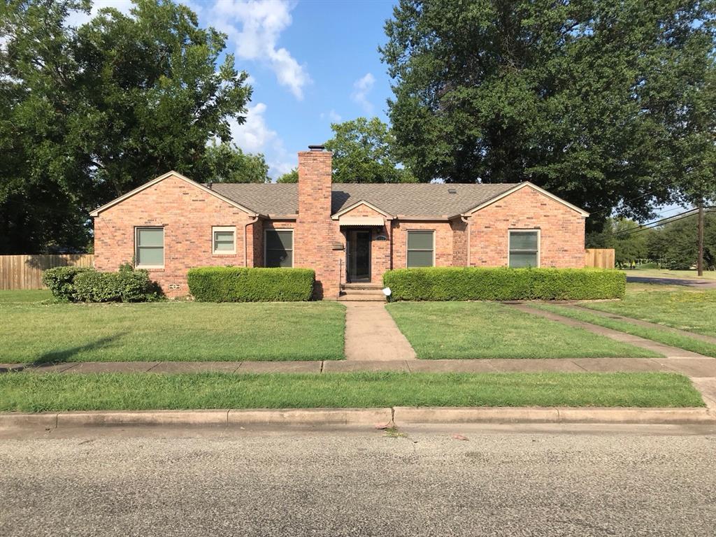 Single story home with brick siding, a chimney, and a shingled roof