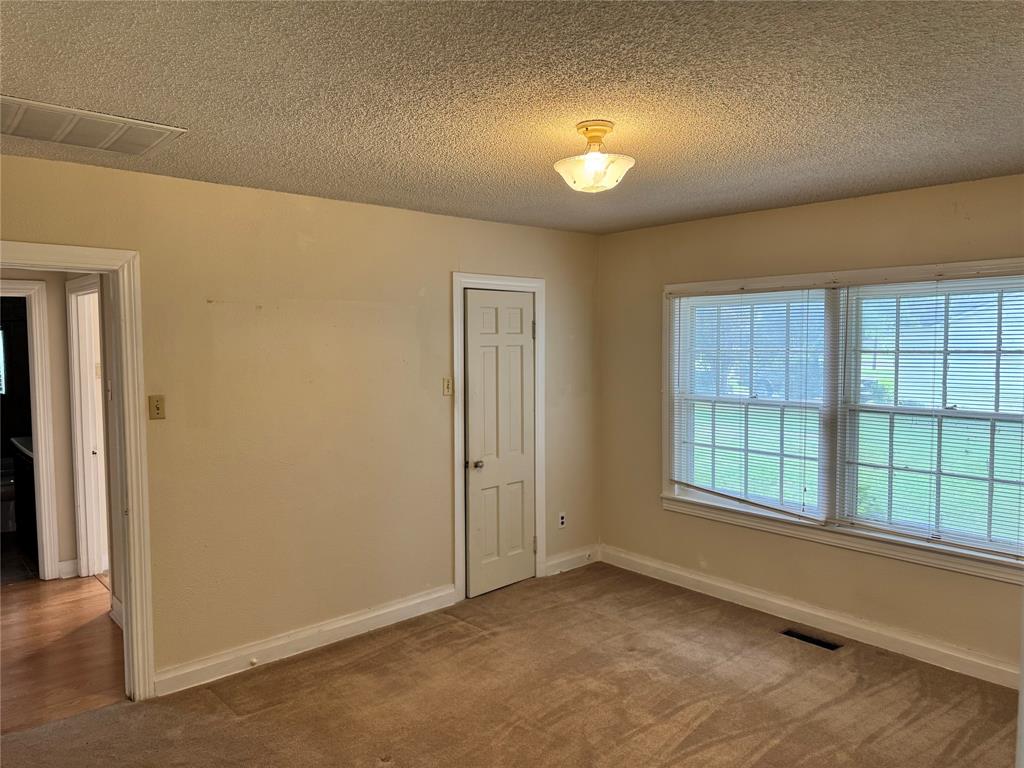 1824 North Binkley Street Sherman, TX 75092 - Photo 13 of 19 Room featuring a textured ceiling and carpet flooring