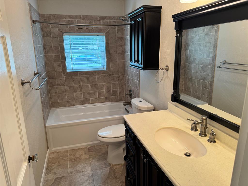 1824 North Binkley Street Sherman, TX 75092 - Photo 15 of 19 Full bath featuring tub / shower combination, vanity, and a textured wall