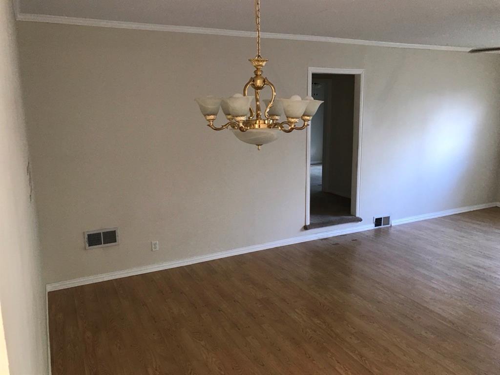 1824 North Binkley Street Sherman, TX 75092 - Photo 6 of 19 Room featuring crown molding, dark wood-style flooring, and a chandelier