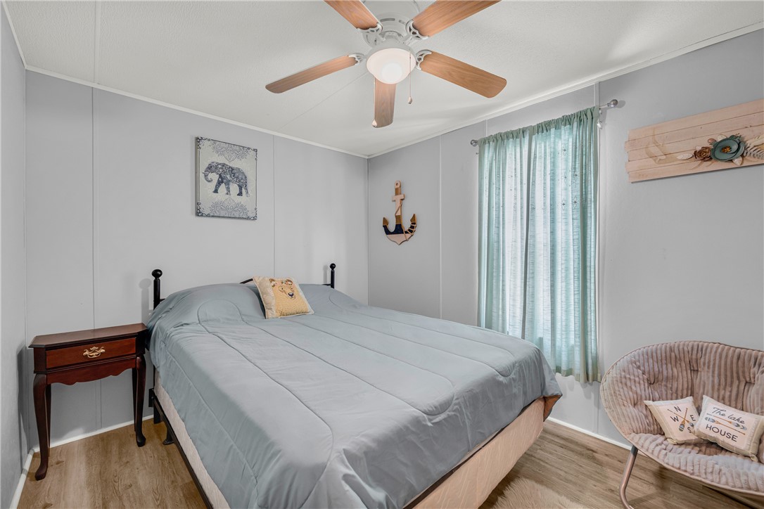 334 Lake Becky Road Mountain Rest, SC 29664 - Photo 22 of 46 The bedroom features a ceiling fan and natural light filtering through the window, creating a serene ambiance.