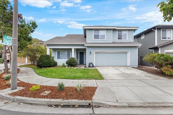 a front view of a house with a yard and a garage