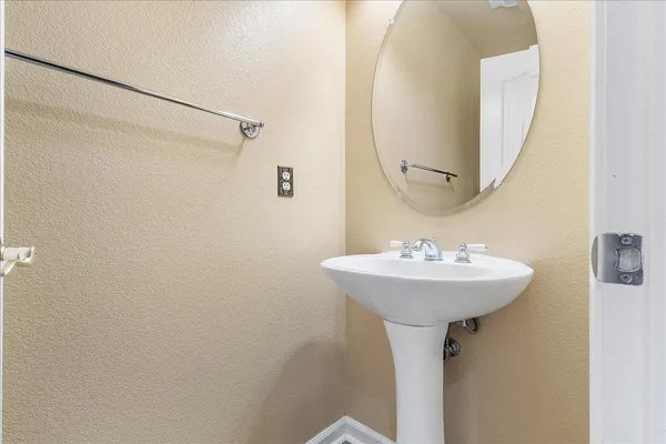 a bathroom with a sink a mirror and shower