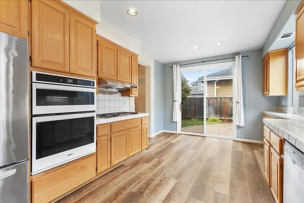 a view of washer and dryer with kitchen in the background
